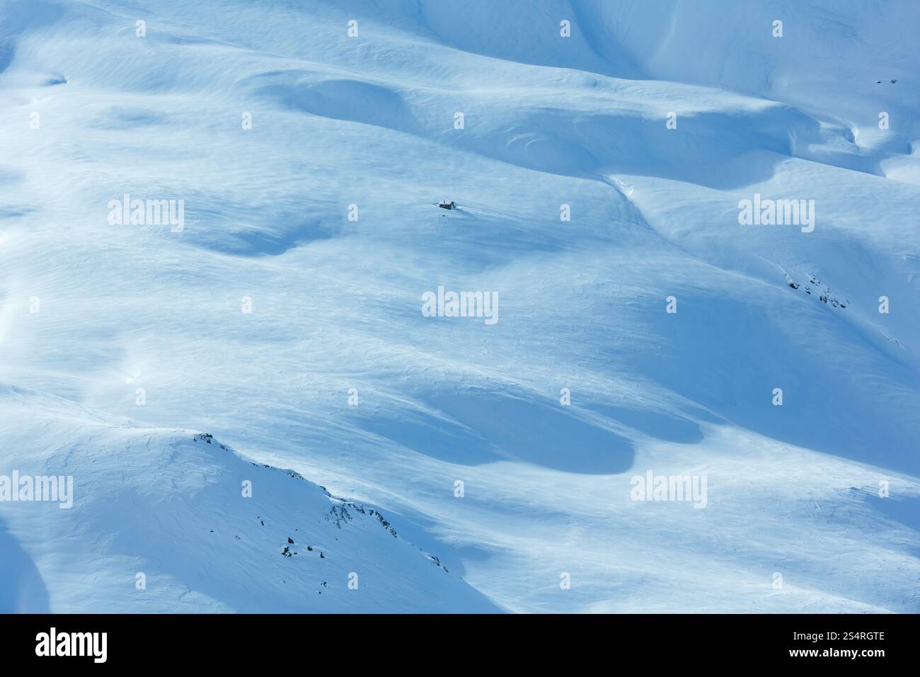 Piccola casa in legno sulla montagna invernale di pendenza. Foto Stock