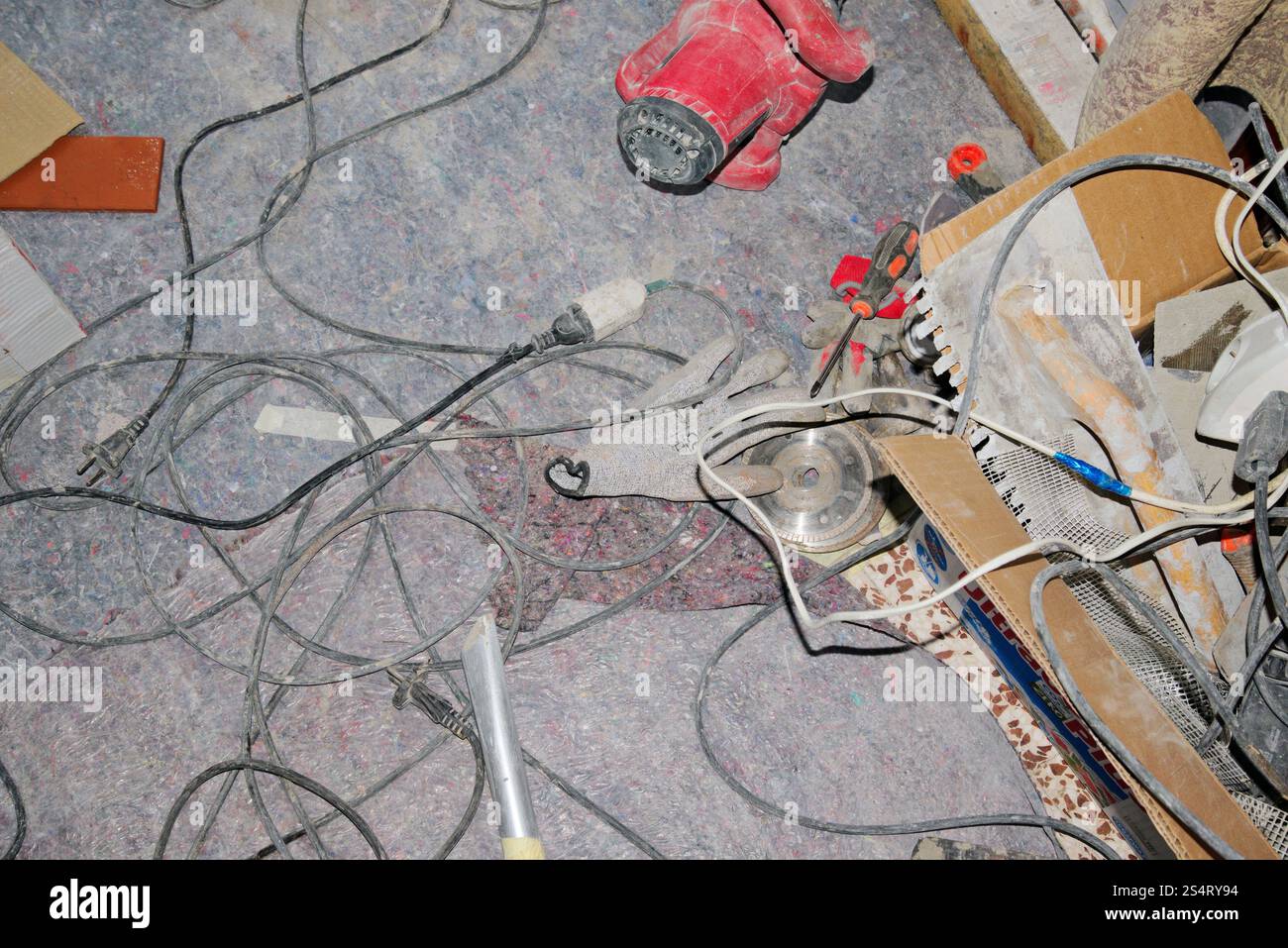 polvere, cavi e utensili sparsi sul pavimento durante i lavori di ristrutturazione della casa Foto Stock