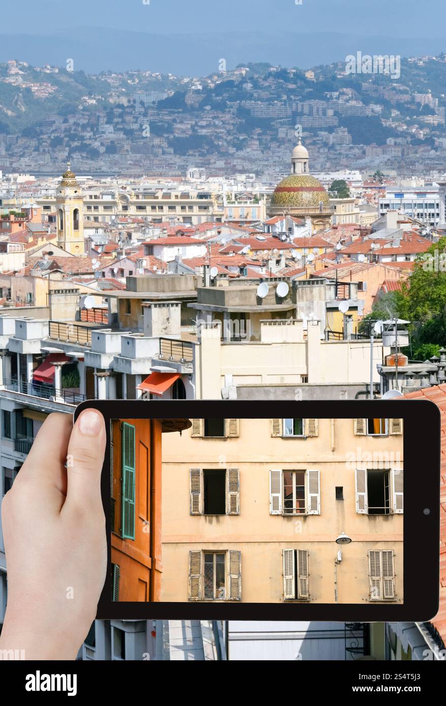 Concetto di viaggio - tourist prende foto di casa nella città vecchia di Nizza, Francia sullo smartphone Foto Stock
