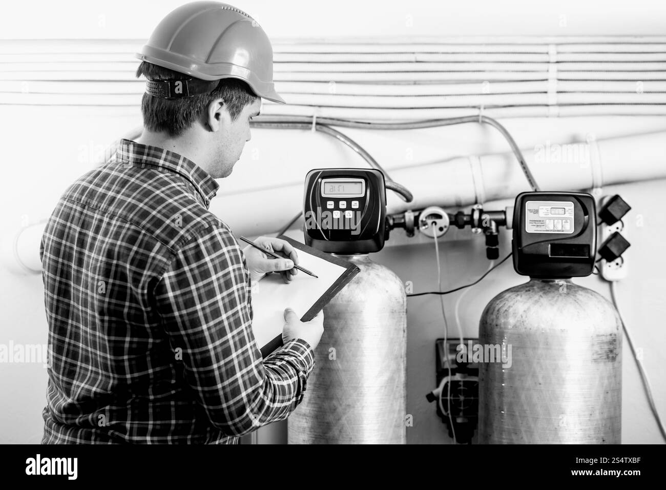 Bianco e nero colpo di ispettore maschio di controllo dell'apparecchiatura di fabbrica Foto Stock