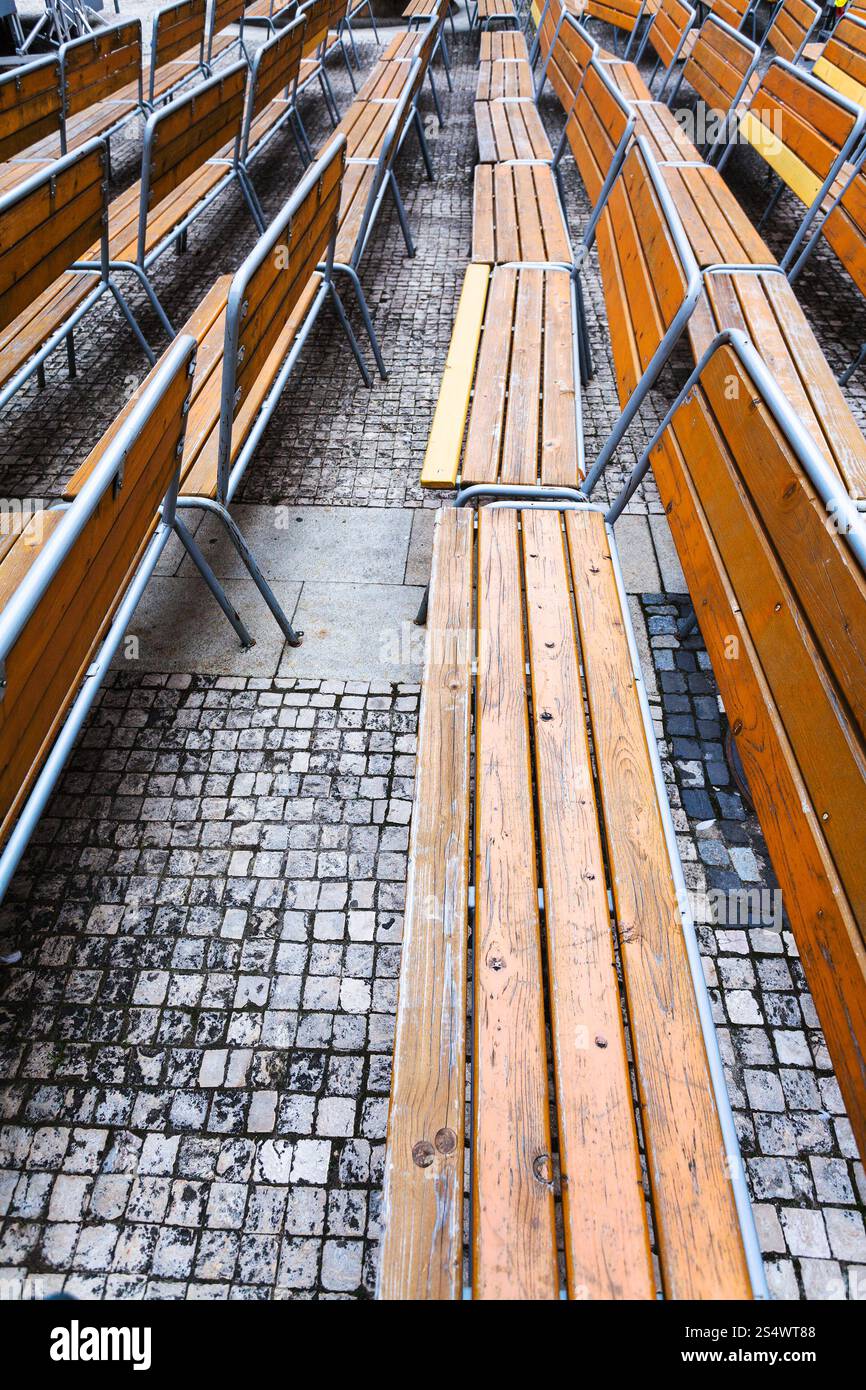 Svuotare le panchine di legno sulla piazza urbana in autunno nella città di Brno Foto Stock