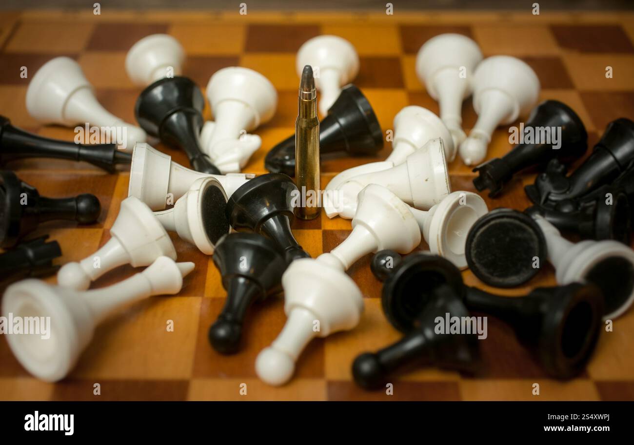 Foto concettuale di arma di potenza. Una pallottola che giace tra i pezzi Foto Stock