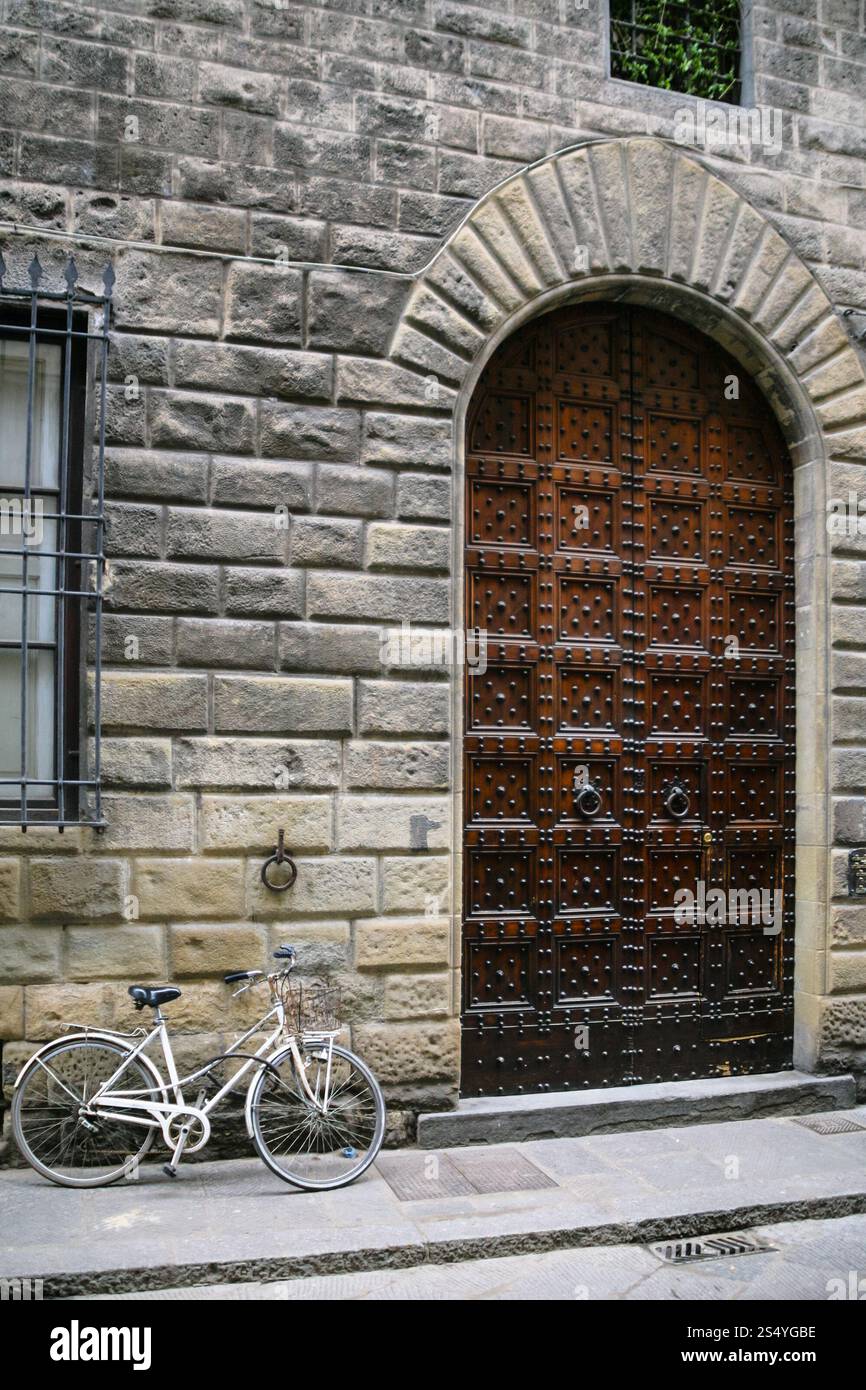 Viaggiare in Italia - bicicletta vicino alla porta della casa medioevale sulla strada di Firenze città nel giorno di inverno Foto Stock