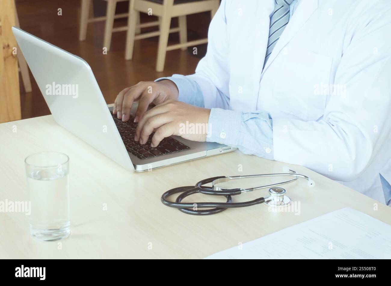 Medico professionista in abito bianco uniforme cappotto di lavoro computer portatile Foto Stock