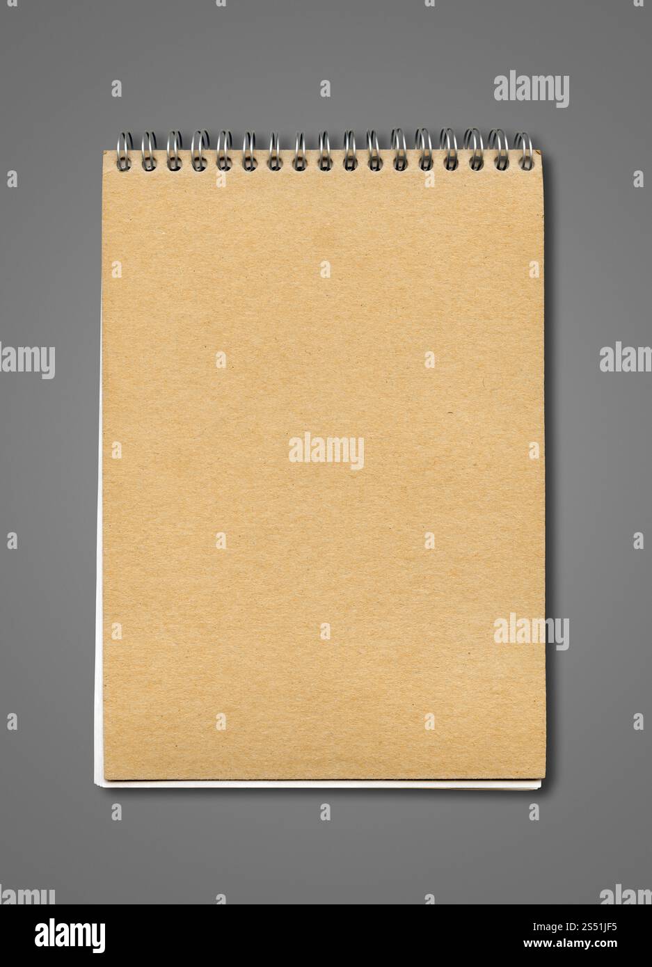 Modello chiuso a spirale per notebook, coperchio in carta marrone, isolato in grigio scuro. Modello di notebook chiuso a spirale Foto Stock