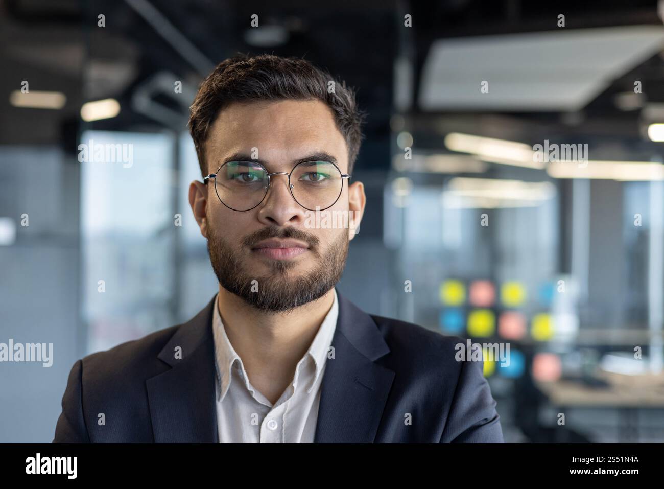 Ritratto ravvicinato di un uomo d'affari sicuro di successo, uomo in tuta professionale che guarda la fotocamera, investitore finanziario sul posto di lavoro all'interno dell'ufficio. Foto Stock
