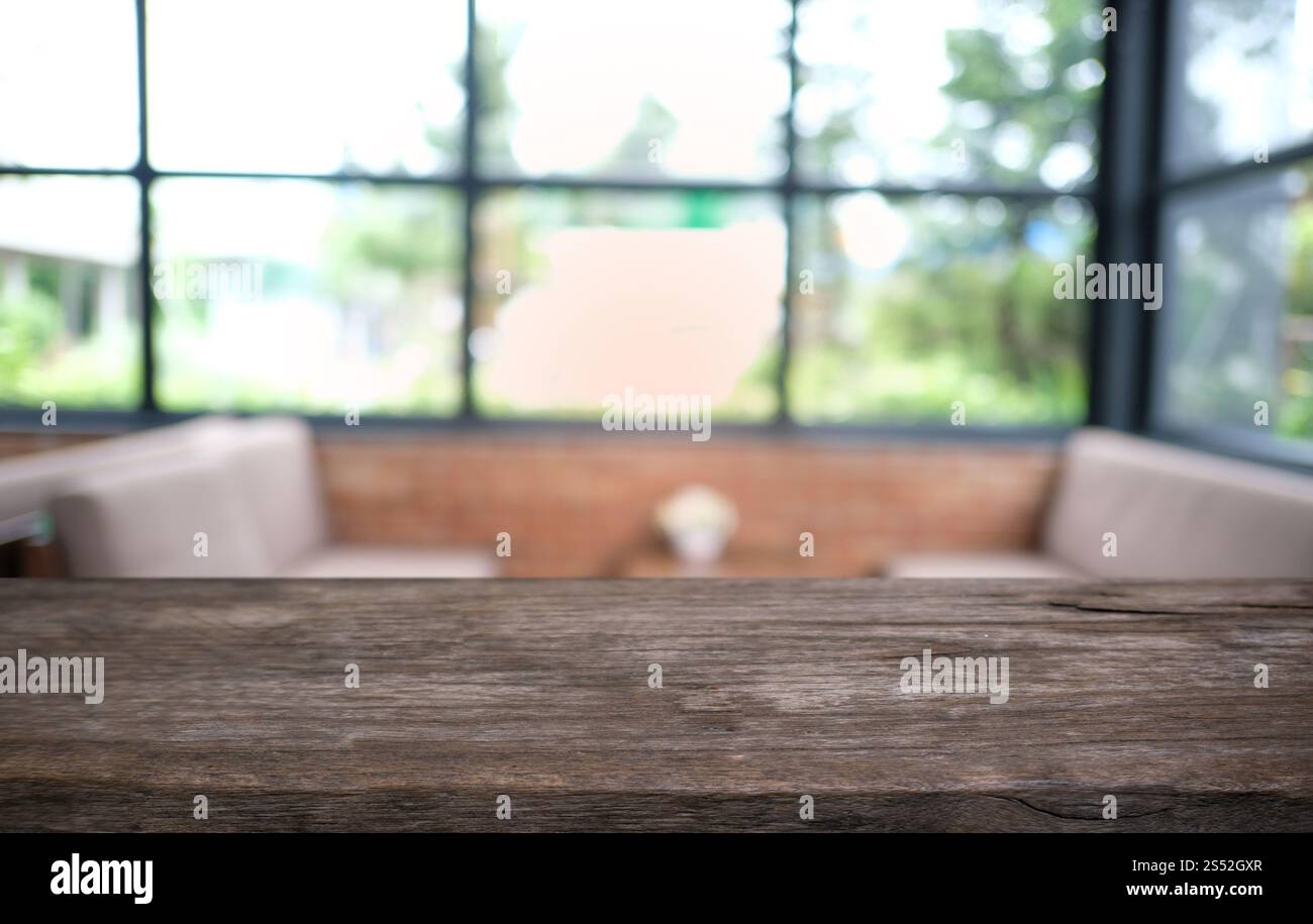Tavolo vuoto di legno scuro davanti allo sfondo bokeh astratto e sfocato del ristorante. può essere utilizzato per la visualizzazione o il montaggio dei prodotti. Mock-up per Foto Stock