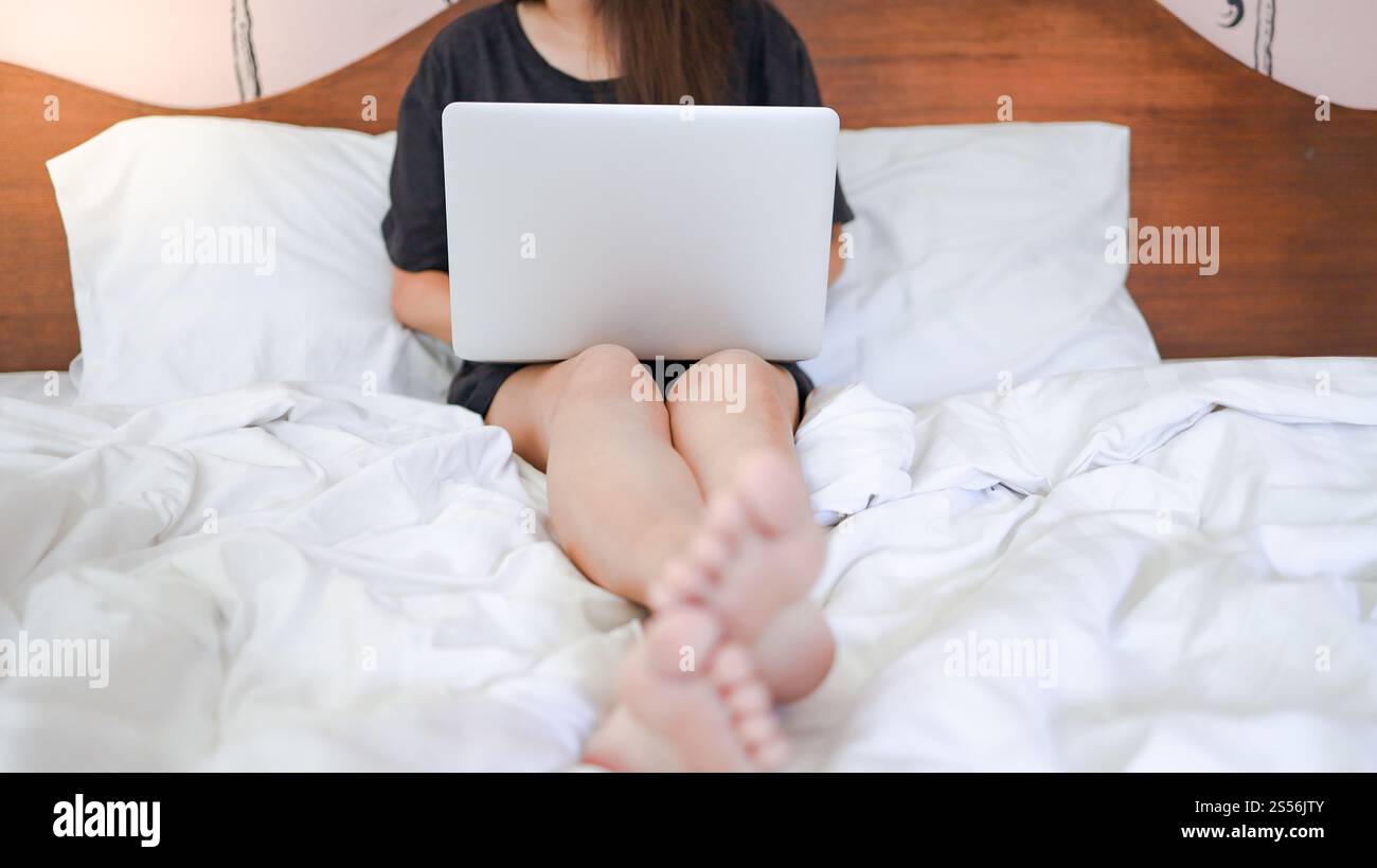 Donna che lavora da casa e imparare isolamento casa auto quarantena donna che lavora su computer portatile mentre si siede in salotto Foto Stock