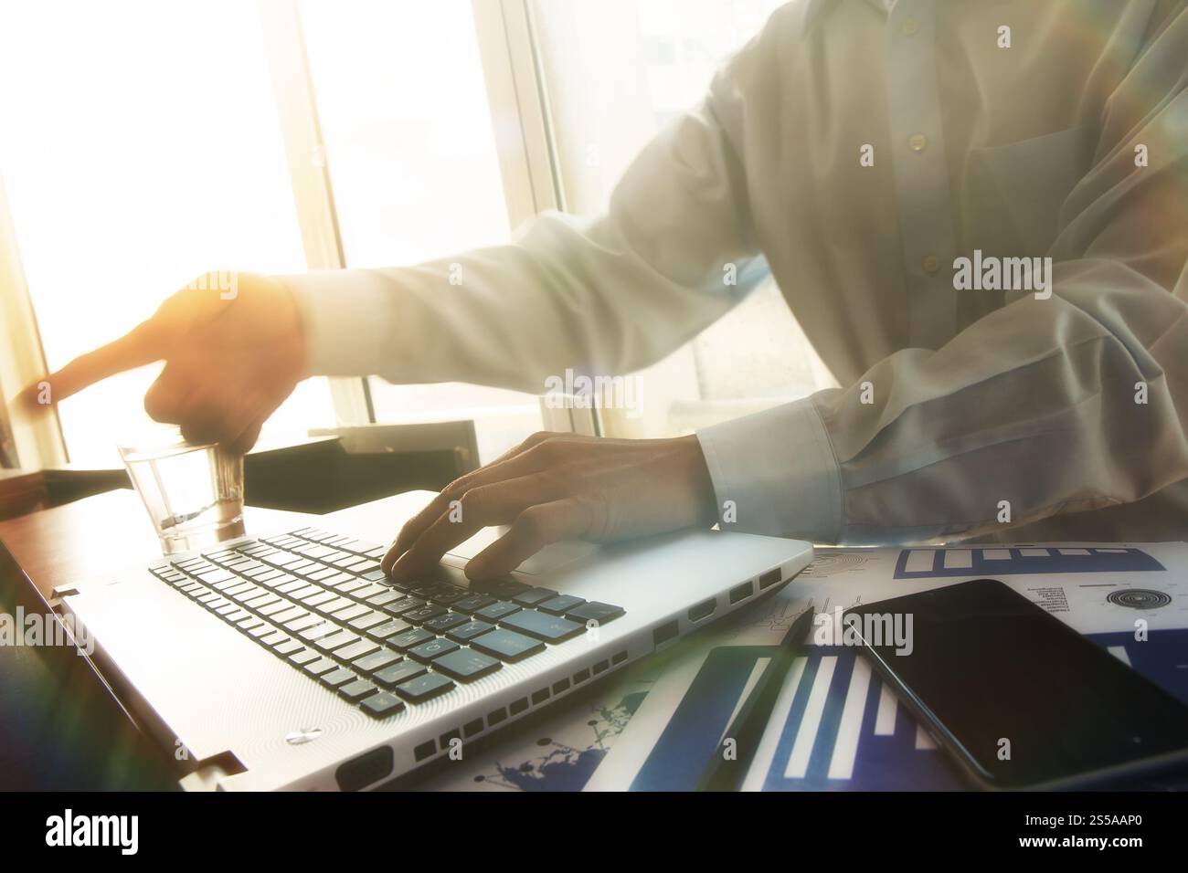 Business man mano lavorando sul computer laptop sulla scrivania di legno come concetto con cielo coperto l'effetto di esposizione Foto Stock