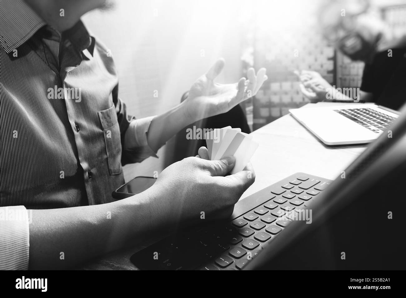 Processo di coworking, team di imprenditori che lavora in un ufficio creativo. utilizzo della base docking digitale per tablet e di un computer portatile con smartphone su marmo Foto Stock