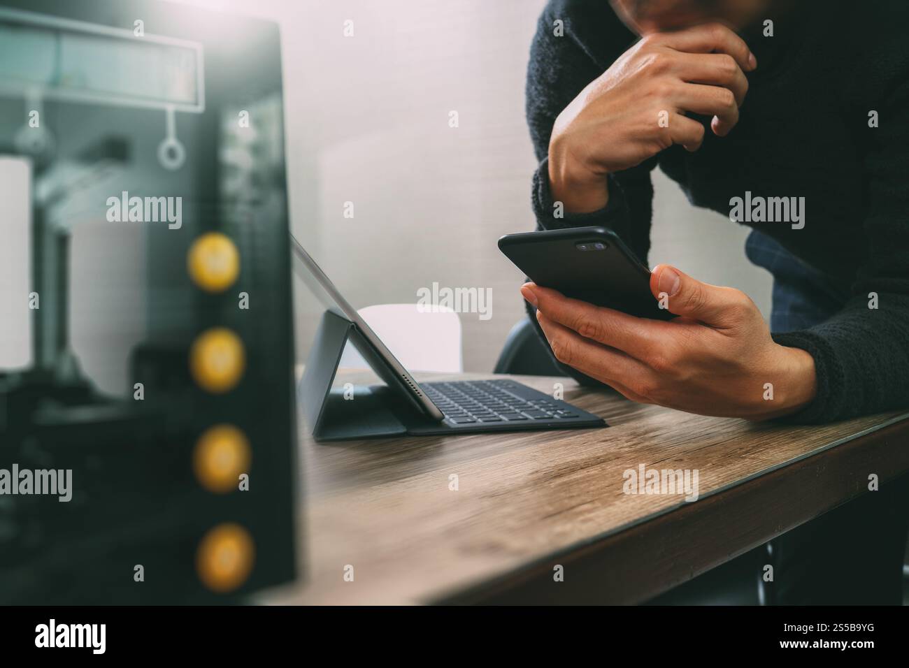 uomo d'affari che usa smartphone, pagamenti mobili online, omni channel, tablet digitale docking tastiera computer, server compatto su legno Foto Stock