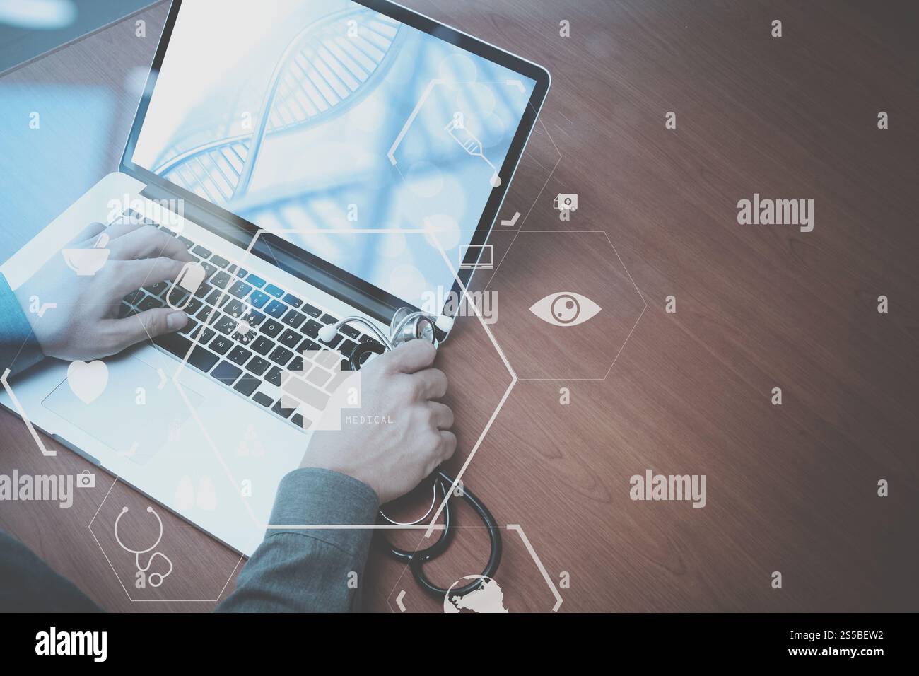 Vista superiore della smart medico lavora con lo stetoscopio e laptop e tablet digitale computer in legno scuro, scrivania con schema Vr Foto Stock