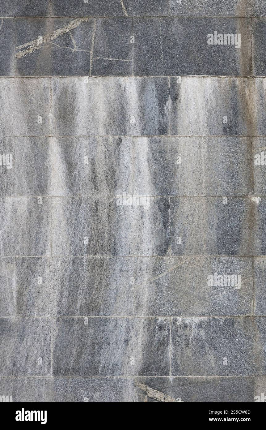 Struttura di sfondo di un muro da un vecchio granito grigio piastrelle Foto Stock