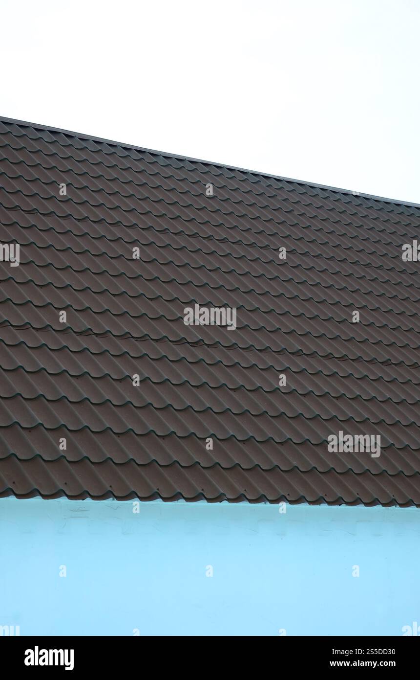 Tegole in metallo marrone. Cerniere per tetti in metallo - costruzione di tetti Foto Stock