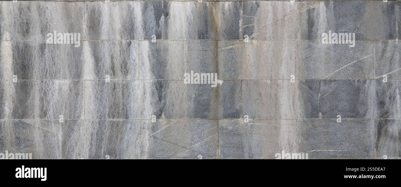 Struttura di sfondo di un muro da un vecchio granito grigio piastrelle Foto Stock