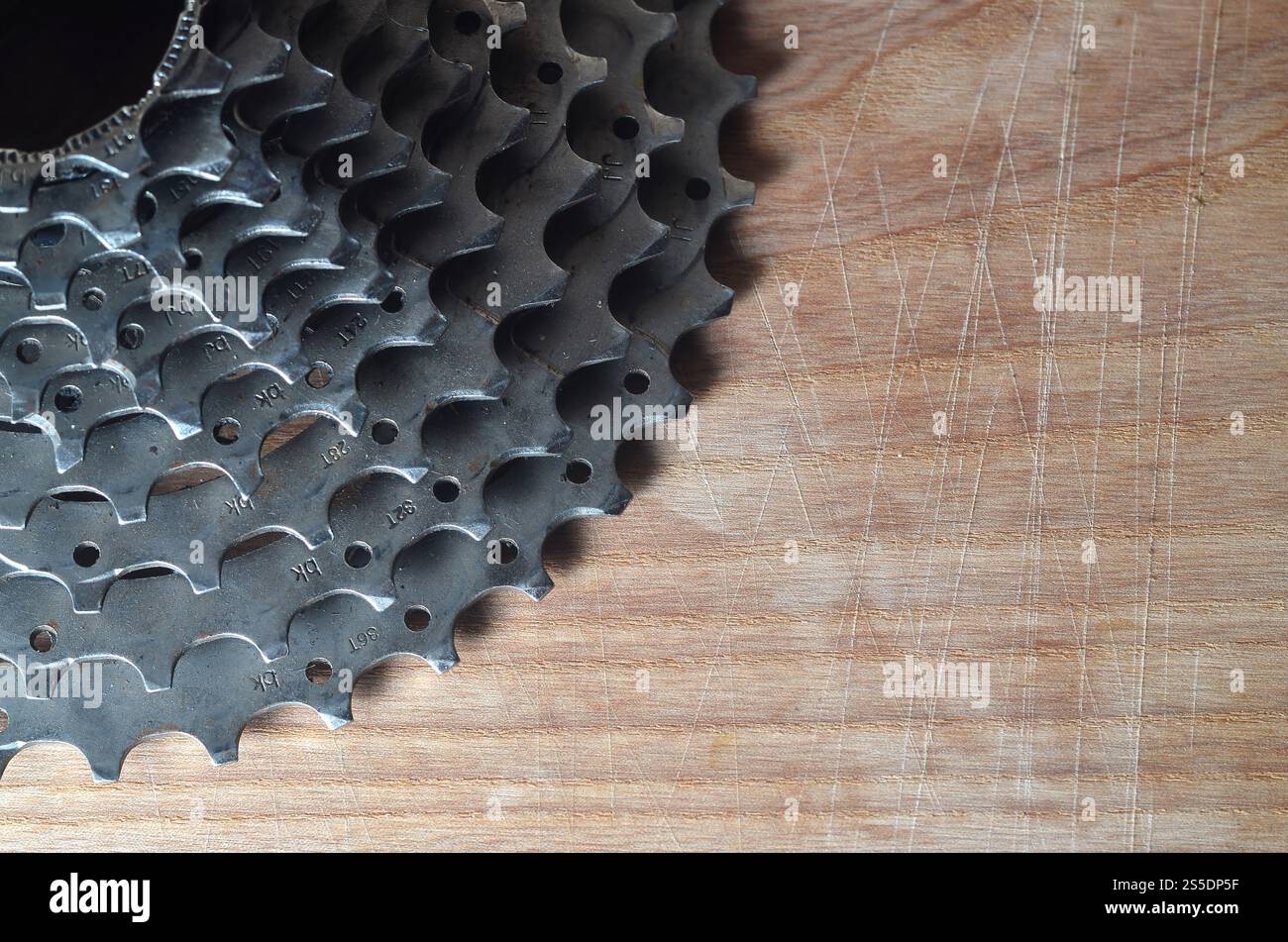 Una fotografia ravvicinata di una cassetta posteriore di una mountain bike stesa su un tavolo di legno in un negozio di biciclette. Uno dei componenti principali per la commutazione Foto Stock