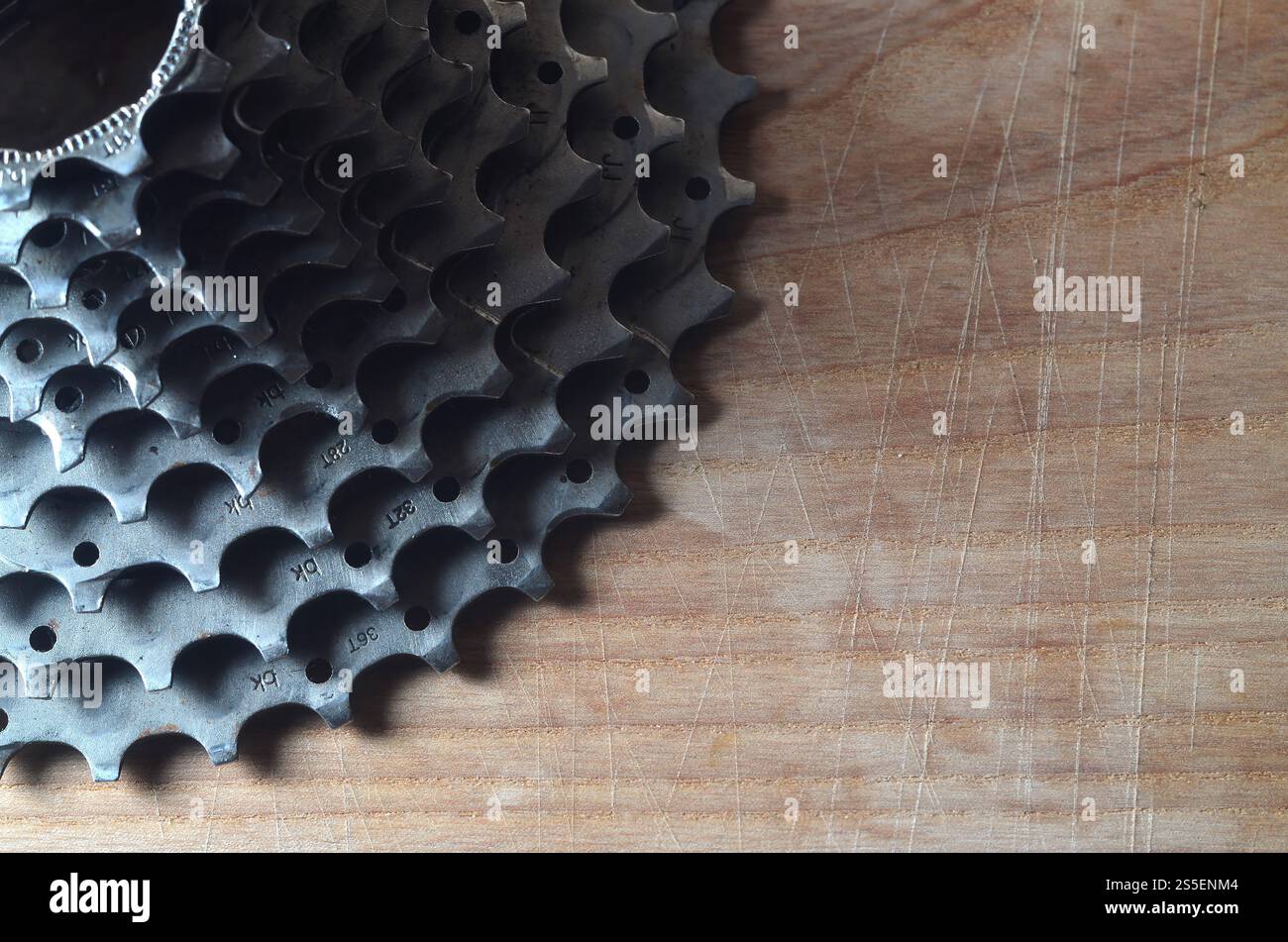 Una fotografia ravvicinata di una cassetta posteriore di una mountain bike stesa su un tavolo di legno in un negozio di biciclette. Uno dei componenti principali per la commutazione Foto Stock