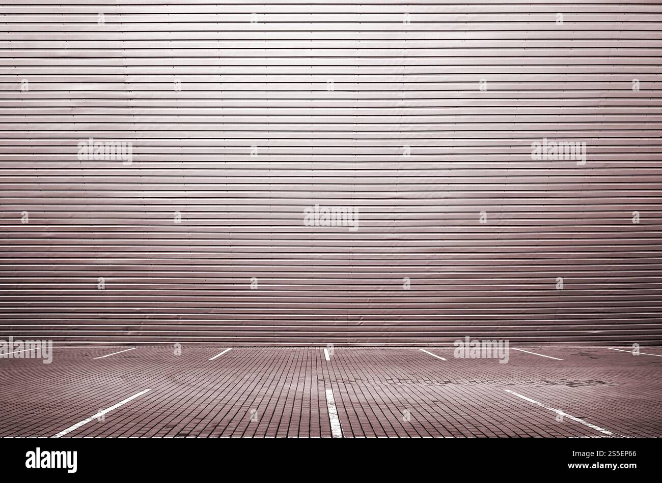Posti auto vuoti sullo sfondo di una parete di metallo con ampio spazio libero per il posizionamento dei prodotti relativi a meccanici e automobili. Parcheggio vuoto Foto Stock