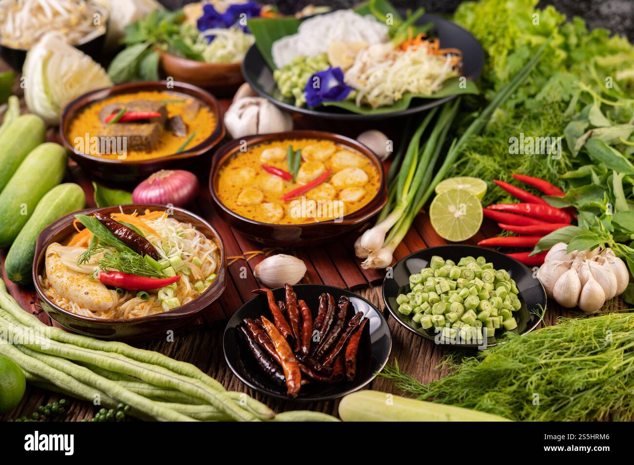 Spaghetti di riso, curry rosso con polpette, con peperoncini secchi, basilico, cetriolo e fagioli lunghi Foto Stock