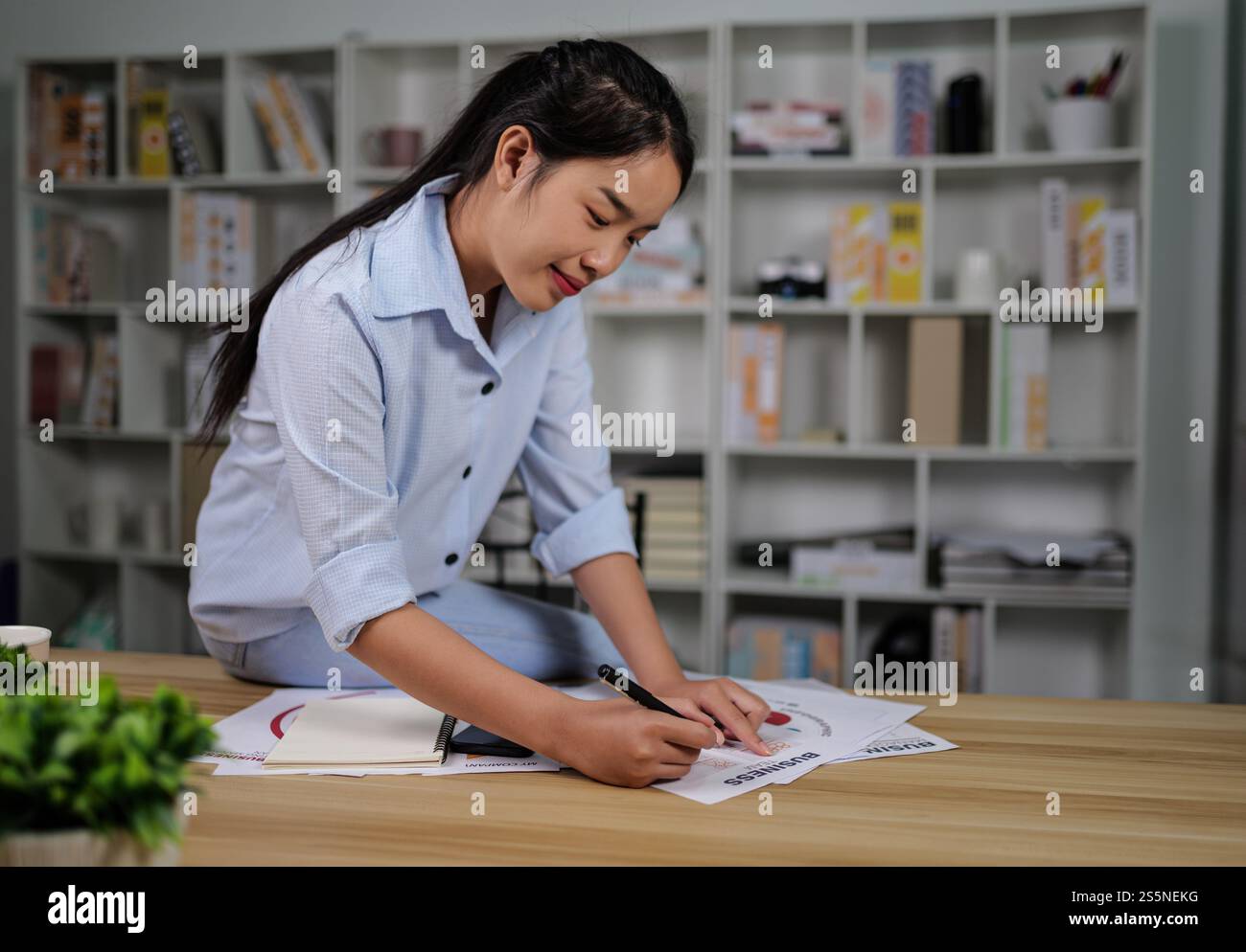 Ritratto di giovane donna asiatica freelance che lavora con documenti sul posto di lavoro a casa, durante la quarantena covid-19 auto isolamento a casa, lavoro Foto Stock