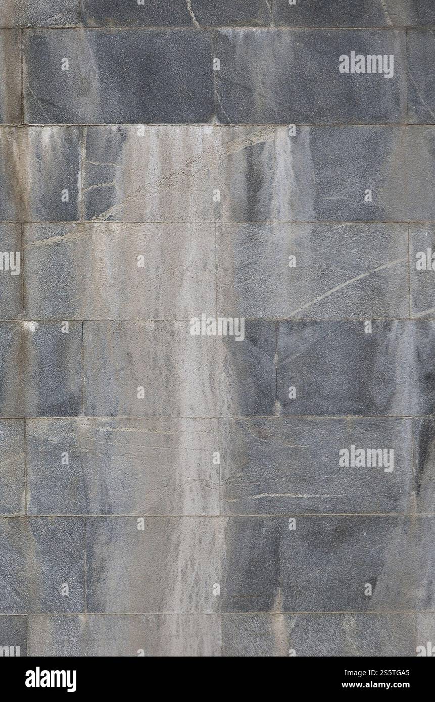 Struttura di sfondo di un muro da un vecchio granito grigio piastrelle Foto Stock