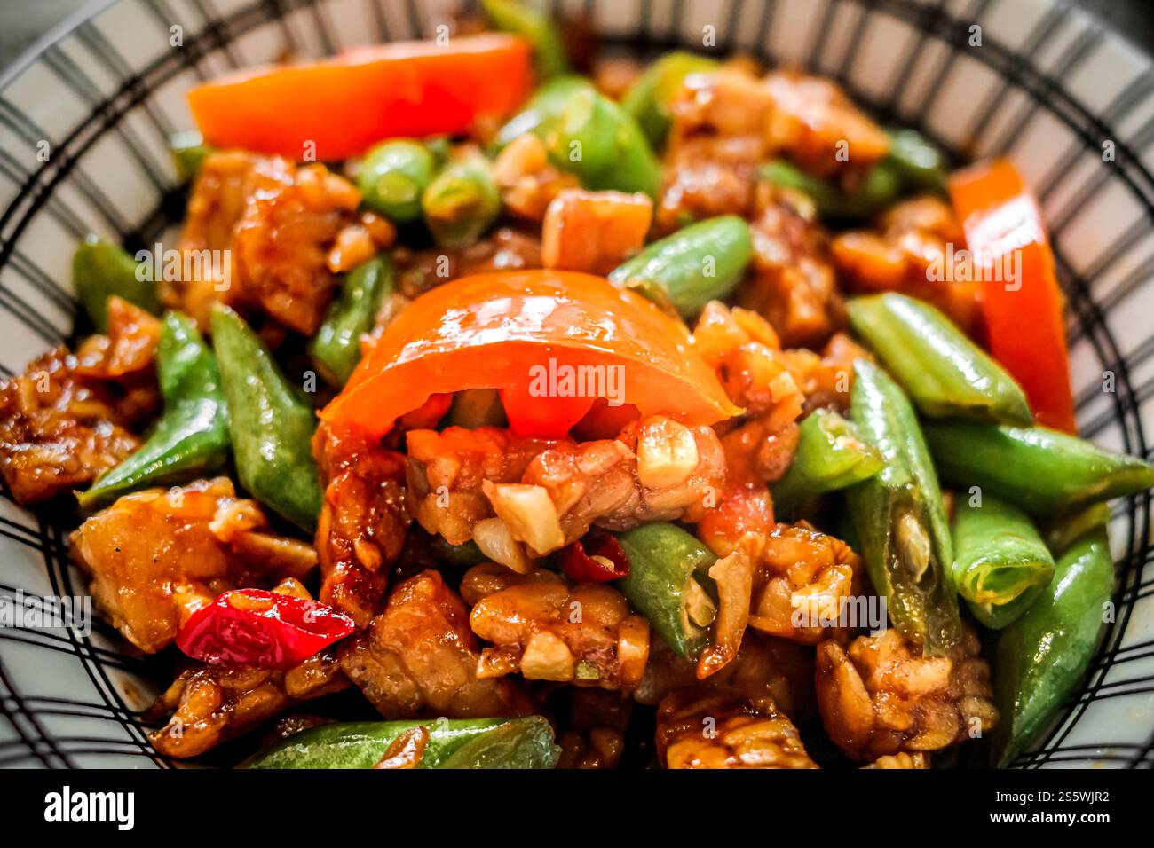 Vista ravvicinata del delizioso menu indonesiano per pranzo con tempeh fritto e fagiolini serviti in una ciotola Foto Stock