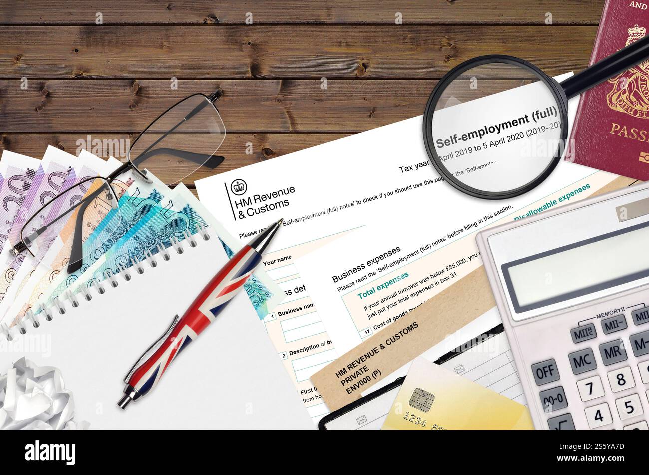 Modulo fiscale inglese sa103 lavoro autonomo da HM revenue and Customs si trova sul tavolo con gli articoli per ufficio. Documentazione HMRC e processo di pagamento delle tasse in United Foto Stock