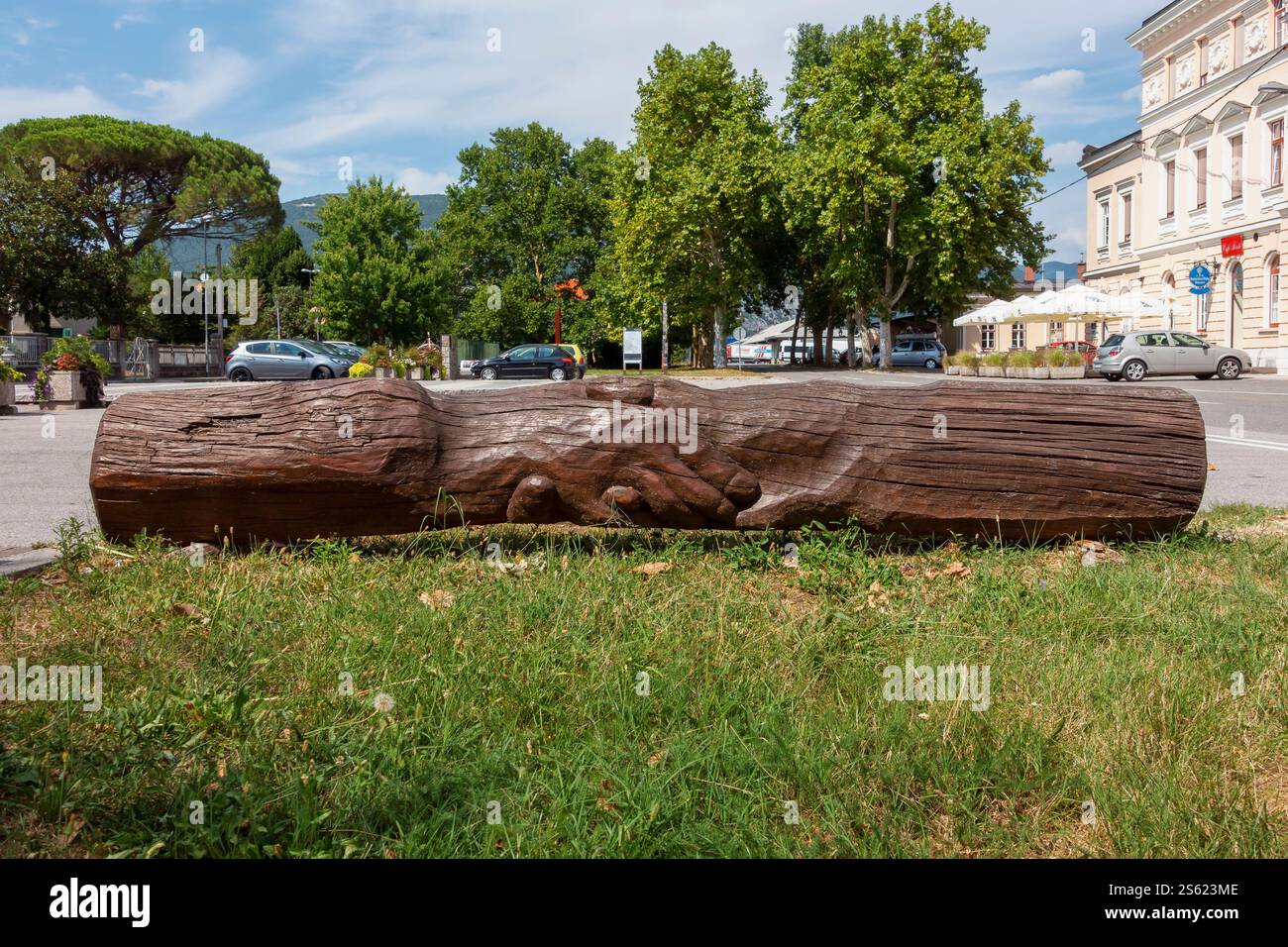 Piazza della Transalpina. Chiusura di mani incisa su un tronco d'albero. Confine tra Gorizia Italia - Nova Gorica Slovenia, Europa, Unione europea Foto Stock