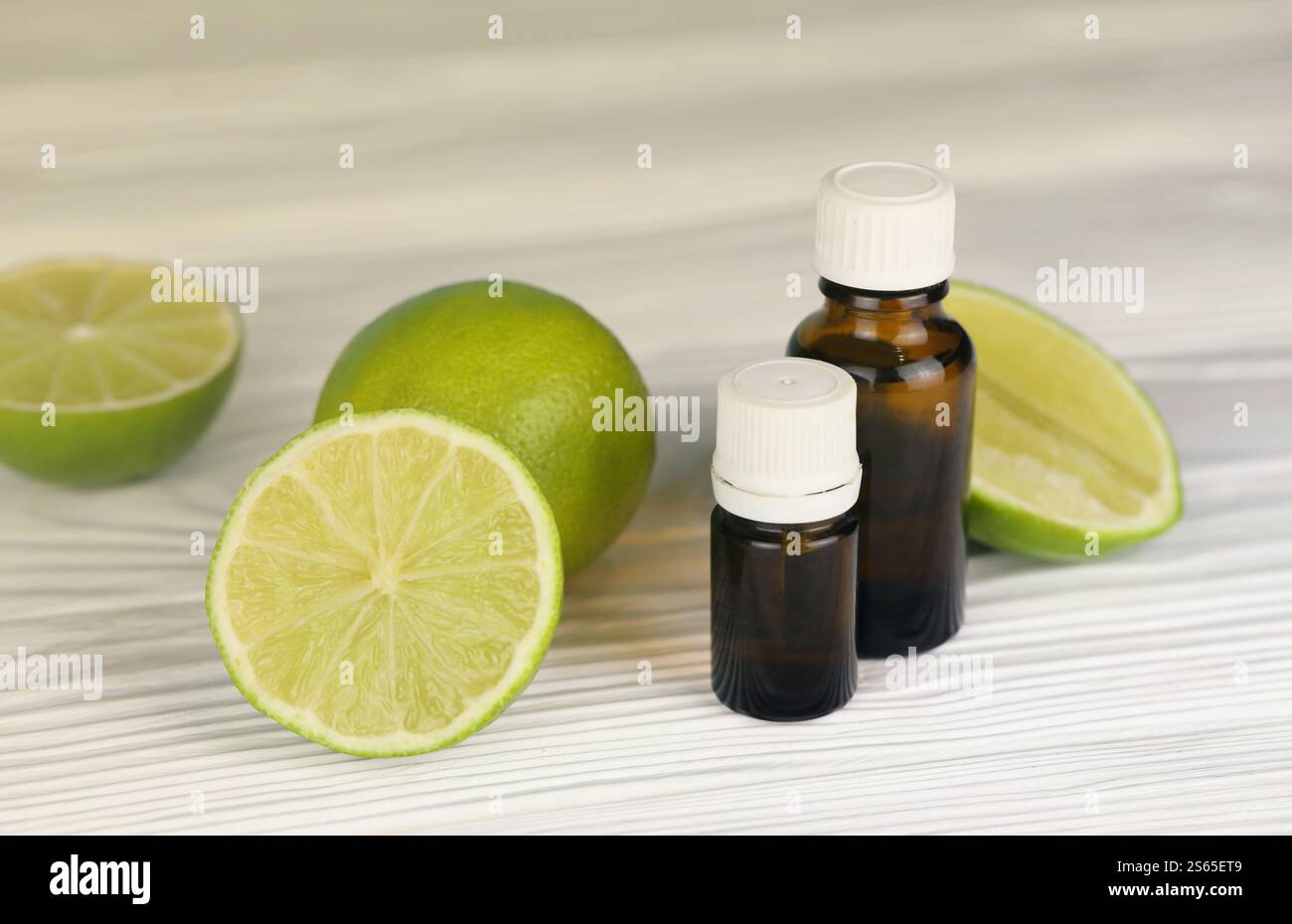 Bottiglia di essenza di olio con estratti di agrumi. Messa a fuoco selettiva. Spa Day, concetto di bottiglia di olio freschezza con estratto di lime. Bottiglia di essenza d'olio con agrumi Foto Stock