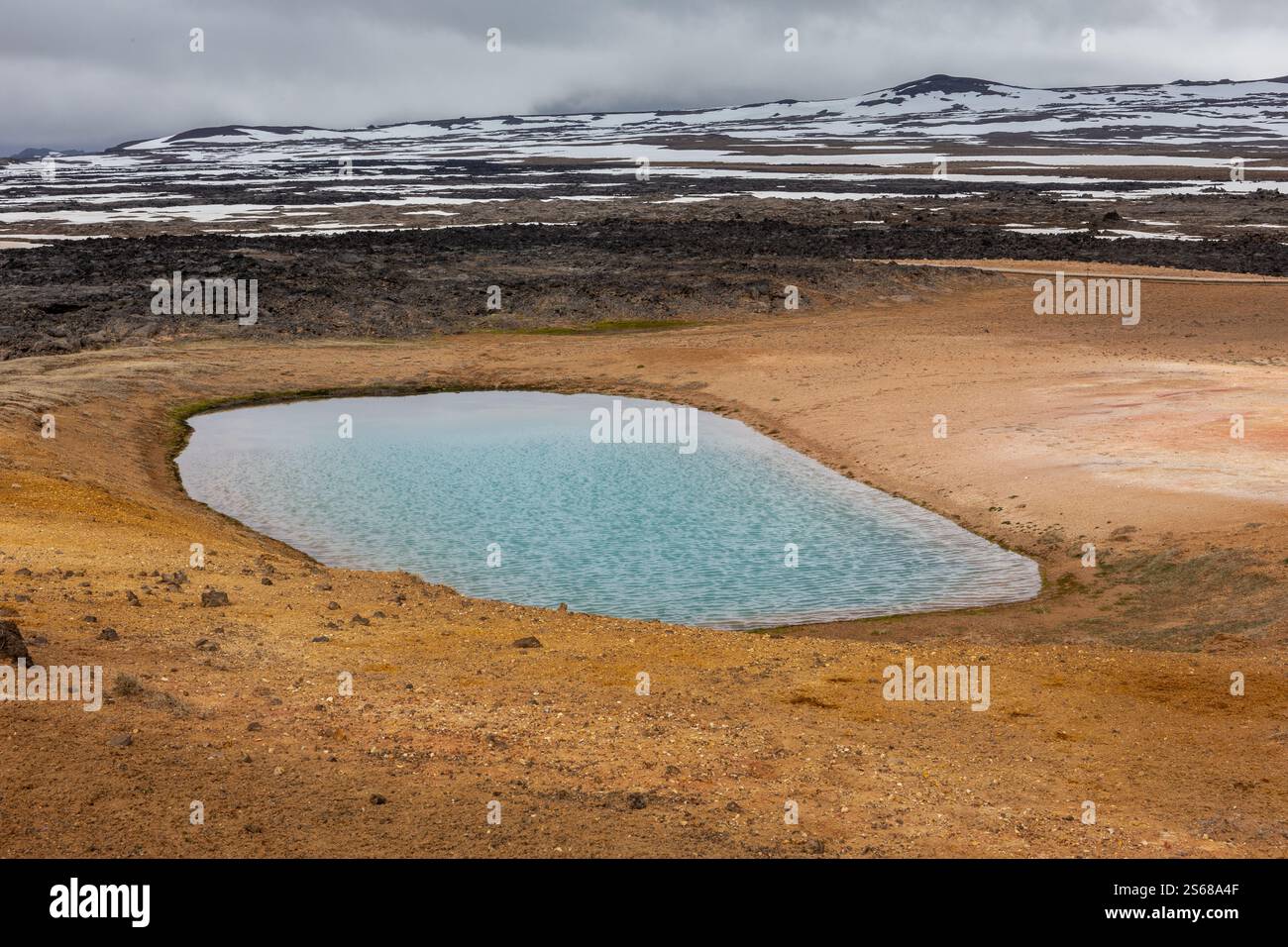 Paesaggio vulcanico di Leirhnjukur, area geotermica di Myvatn in Islanda, con lago turchese solforico e montagne sullo sfondo. Foto Stock