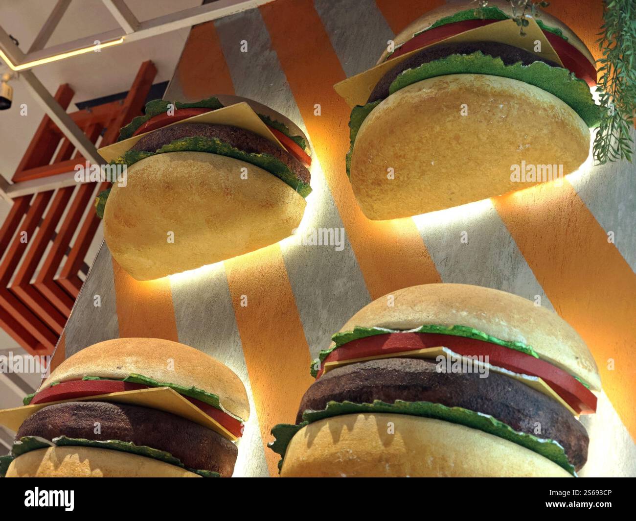 Grandi repliche di hamburger usate come decorazione delle pareti del ristorante Foto Stock