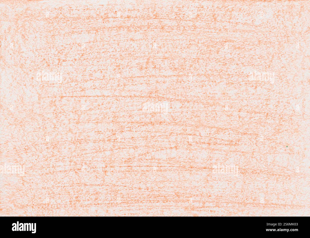 Grana di cera di colore arancione su un foglio di carta bianco Foto Stock