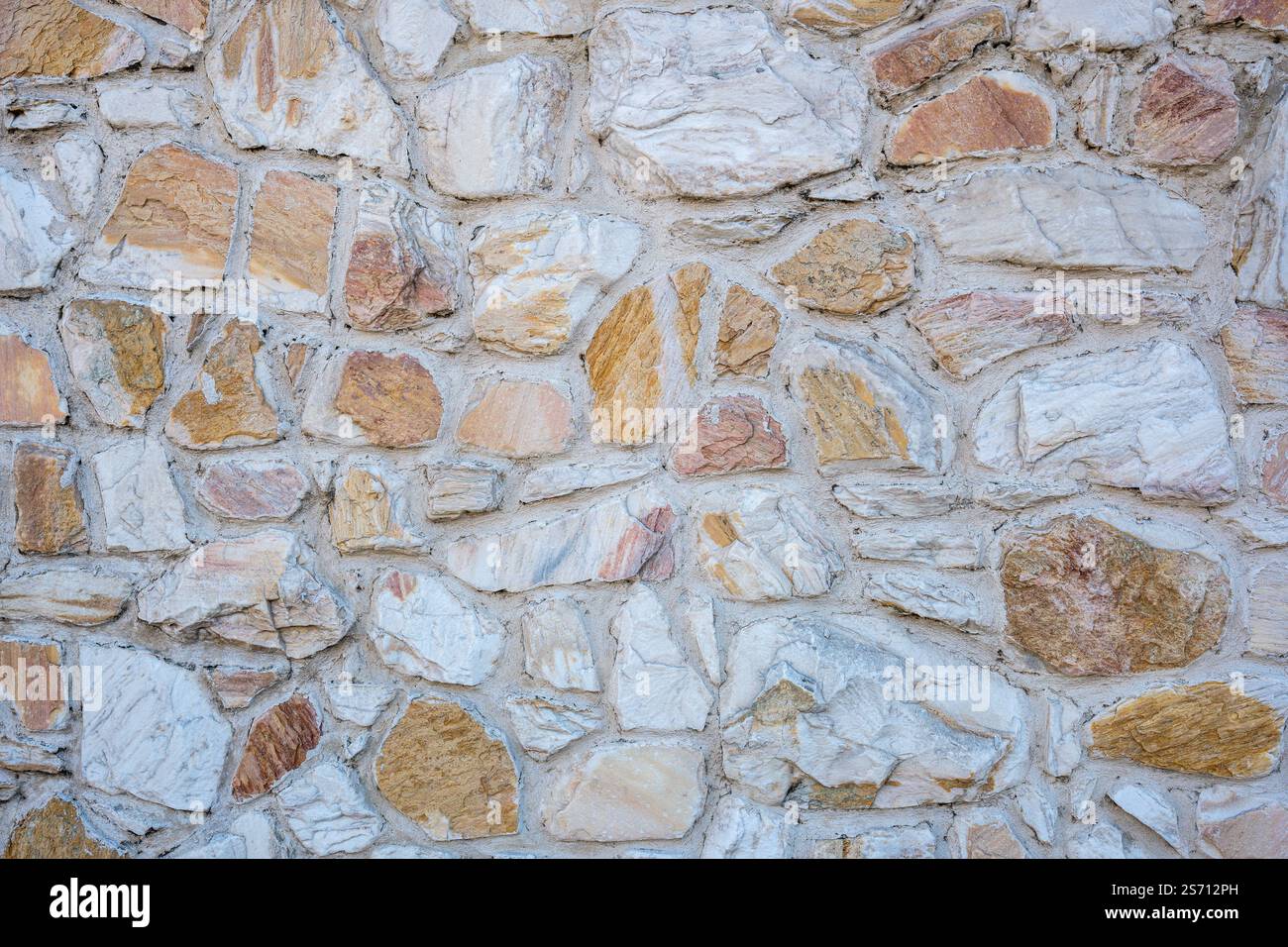 Sfondo di un vecchio muro di pietra naturale Foto Stock