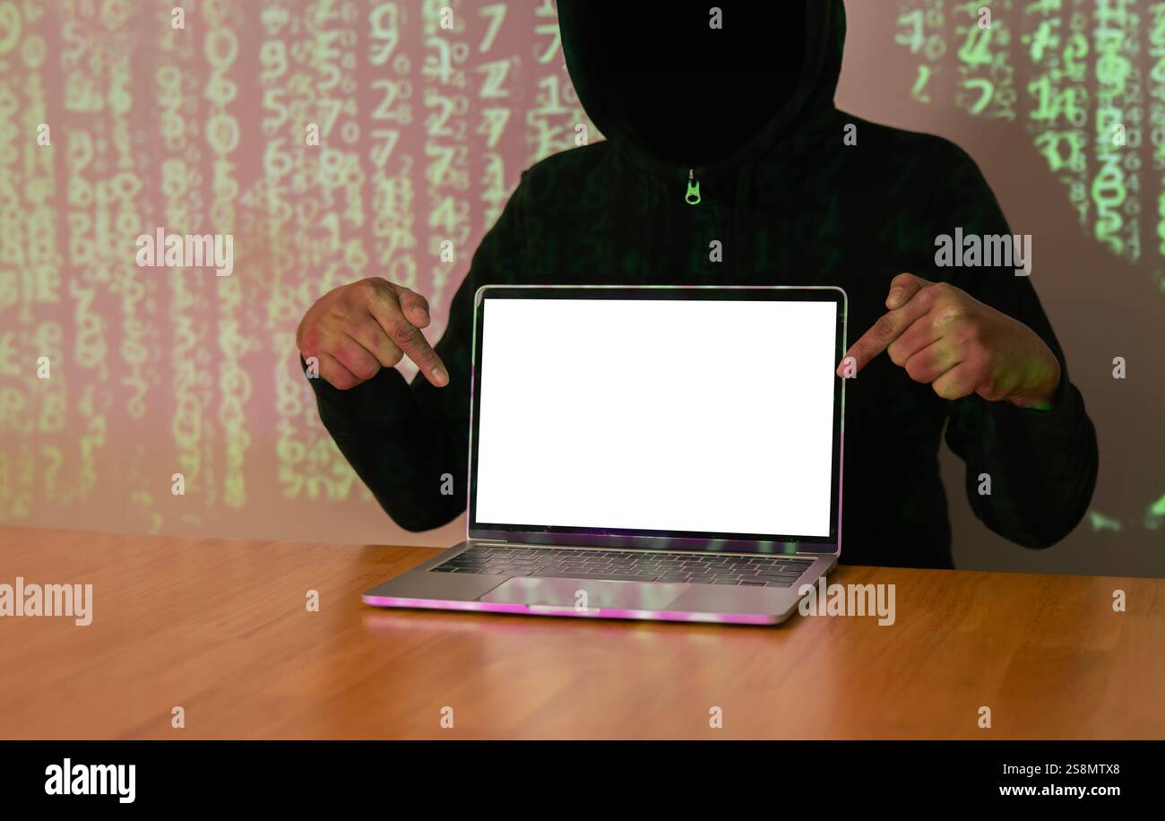 Hacker con volto oscuro che punta le mani e mostra il laptop mentre ruba big data e informazioni finanziarie. Copia sapce. Foto Stock