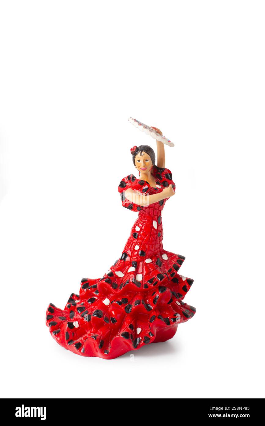 Una bambola vestita da ballerina di flamenco che tiene un fan su uno sfondo bianco Foto Stock