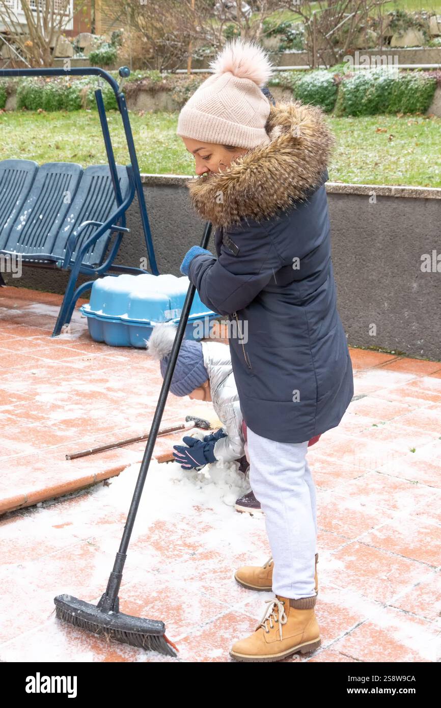 Rimozione della neve come modo per trascorrere del tempo con la famiglia Foto Stock