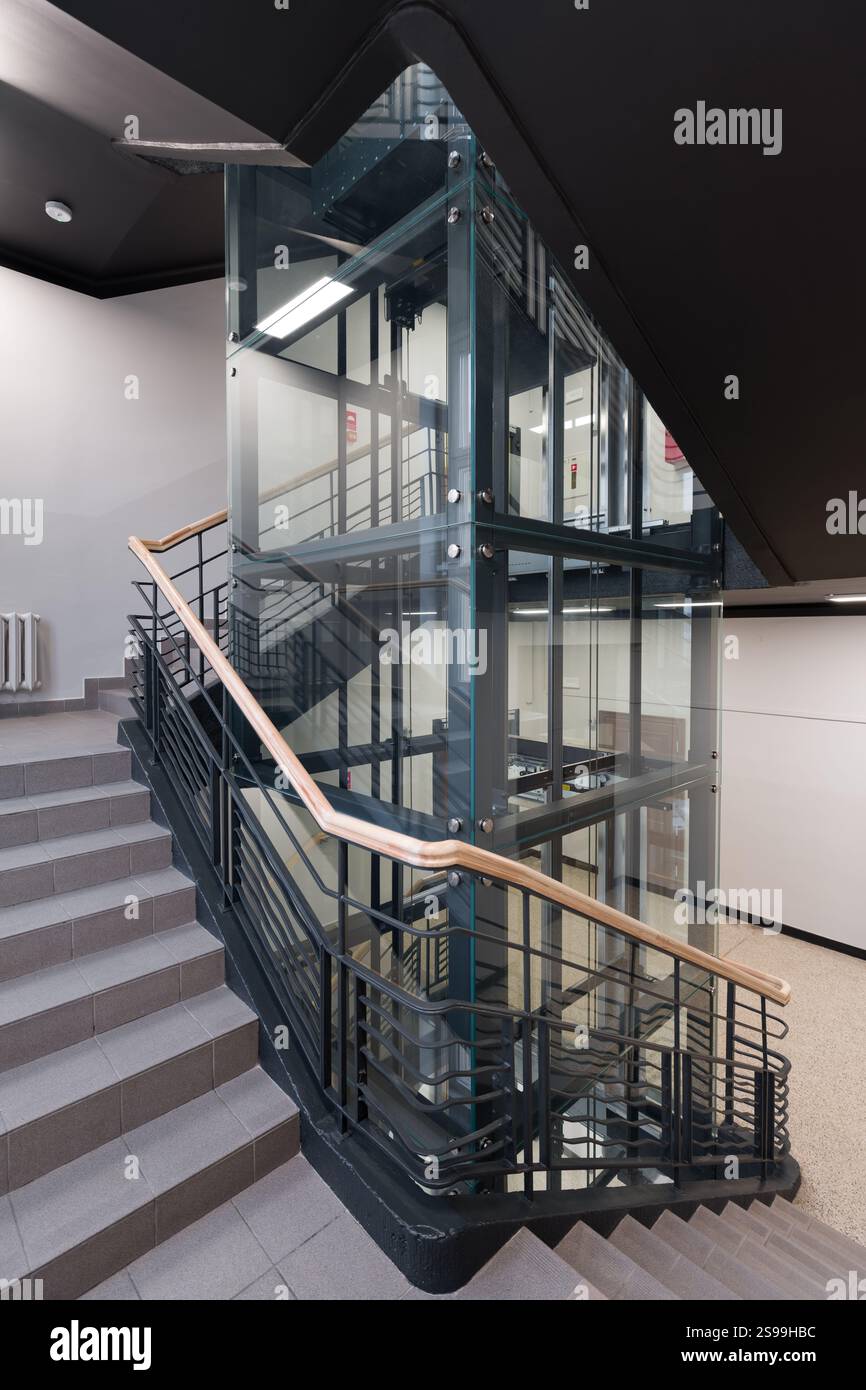 Moderno ascensore in vetro e design a scala a spirale Foto Stock