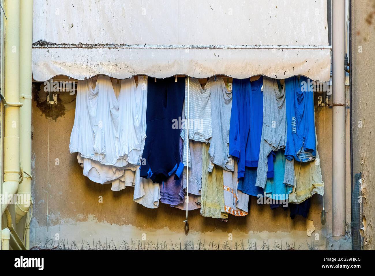 Lavanderia appesa sotto una tenda resistente agli agenti atmosferici nel quartiere storico di Bari Vecchia, Bari, Italia. Foto Stock