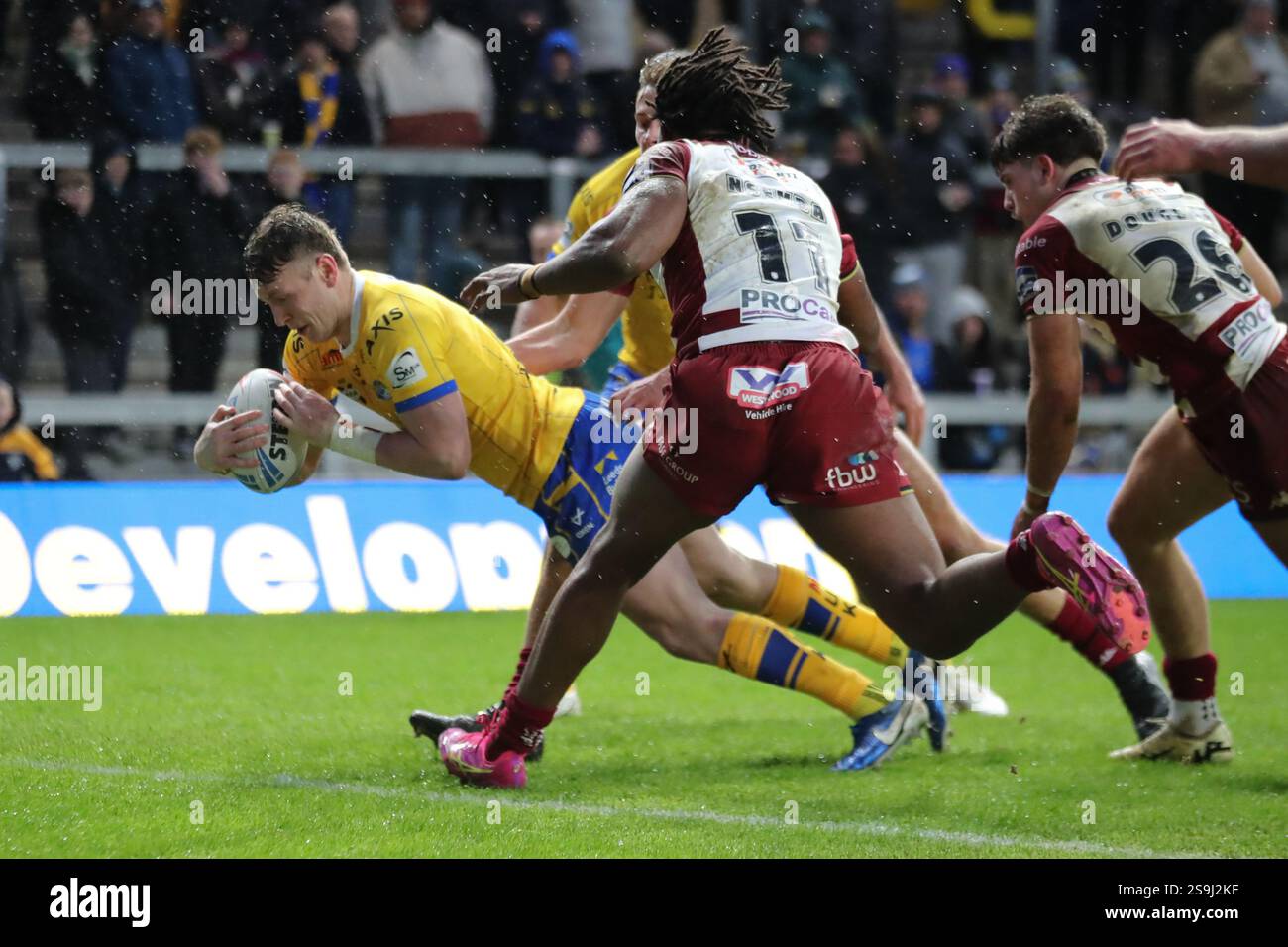 Leeds, Regno Unito. 26 gennaio 2025. AMT Headingley Rugby Stadium, Leeds, West Yorkshire, 26 gennaio 2025. Ash HandleyÕs Testimonial Leeds Rhinos V Wigan Warriors Harry Newman of Leeds Rhinos si tuffa per segnare una meta contro Wigan Warriors Credit: Touchlinepics/Alamy Live News Foto Stock