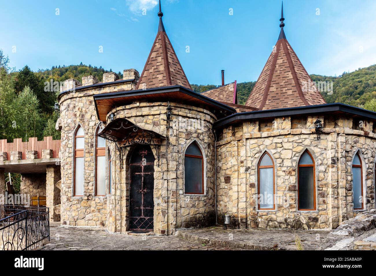 Un castello con un grande tetto in pietra e una piccola finestra. Il castello è vecchio e ha uno stile gotico Foto Stock