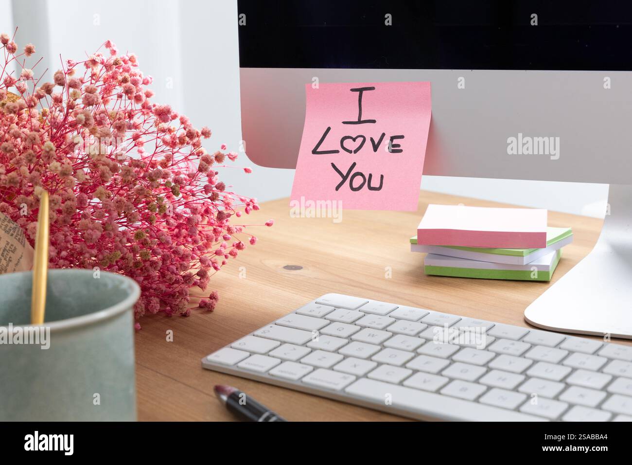 Immagine sconcertante dello schermo di un computer con una nota adesiva allegata, che mostra il messaggio scritto a mano "i Love you", che simboleggia l'amore, l'affetto, un Foto Stock