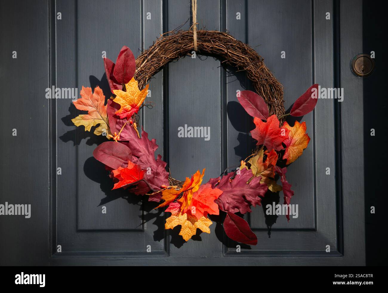Una corona di porte floreali natalizie appesa su una porta d'ingresso a York, nel North Yorkshire. Foto Stock