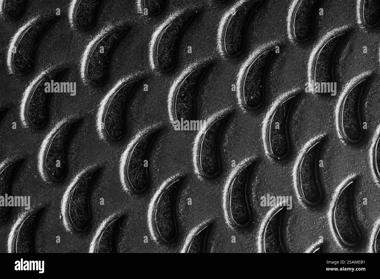 Superficie ruvida che mostra un primo piano di un motivo metallico nero utilizzato nelle applicazioni industriali Foto Stock