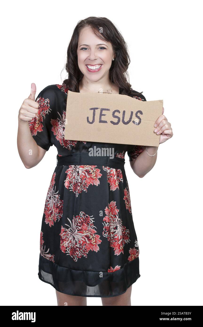 Una bella giovane donna che regge un cartello di Gesù Foto Stock