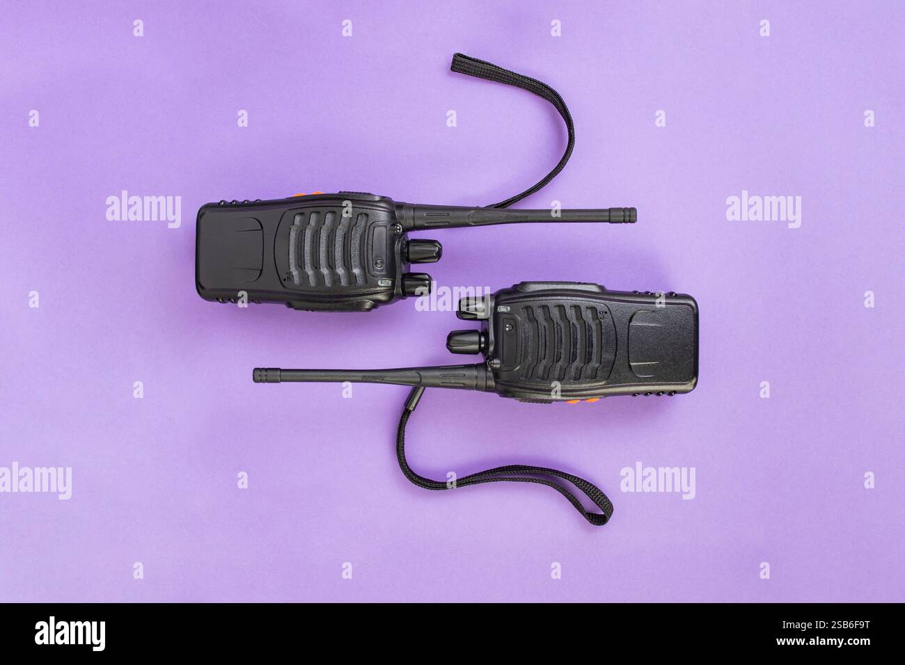 Due walkie talkie in plastica nera su carta viola Foto Stock