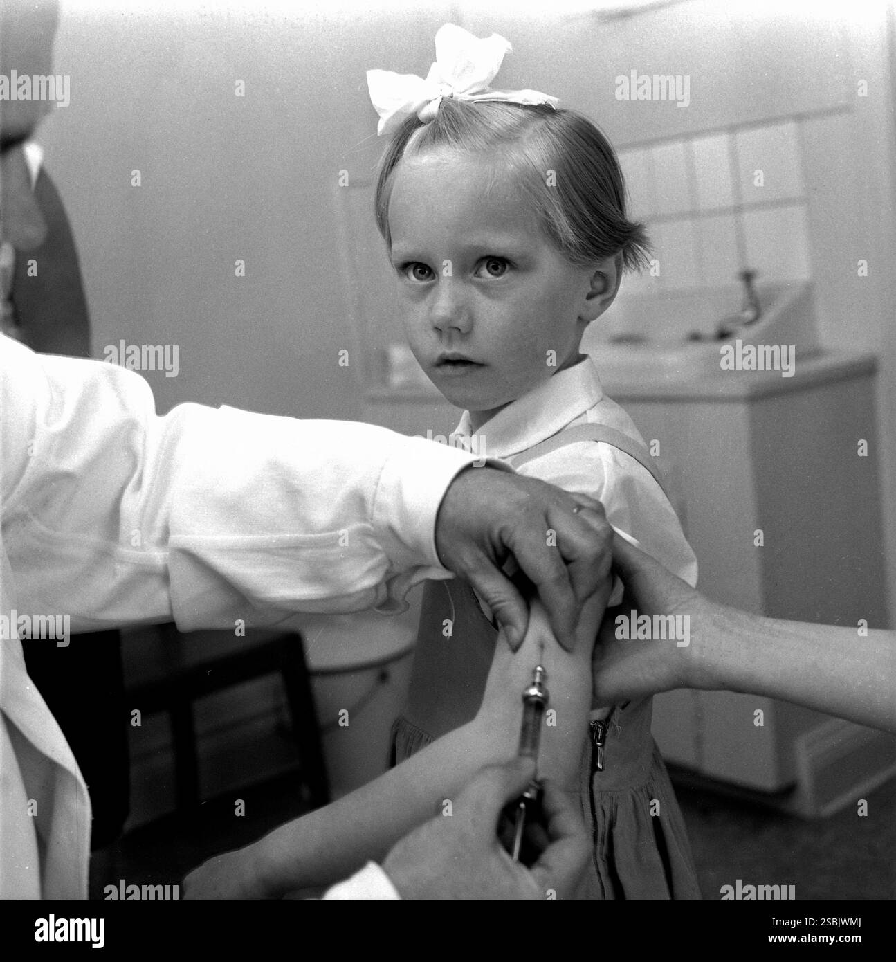 Una ragazza che riceve il vaccino antipolio, Svezia, aprile 1957. Foto di Orebro Kuriren. Il primo vaccino antipolio efficace è stato sviluppato nel 1952 da Jonas Salk e un team presso l'Università di Pittsburgh. Il vaccino di Salk è stato autorizzato nel 1955, dopo di che sono state lanciate campagne di vaccinazione per bambini. Foto Stock