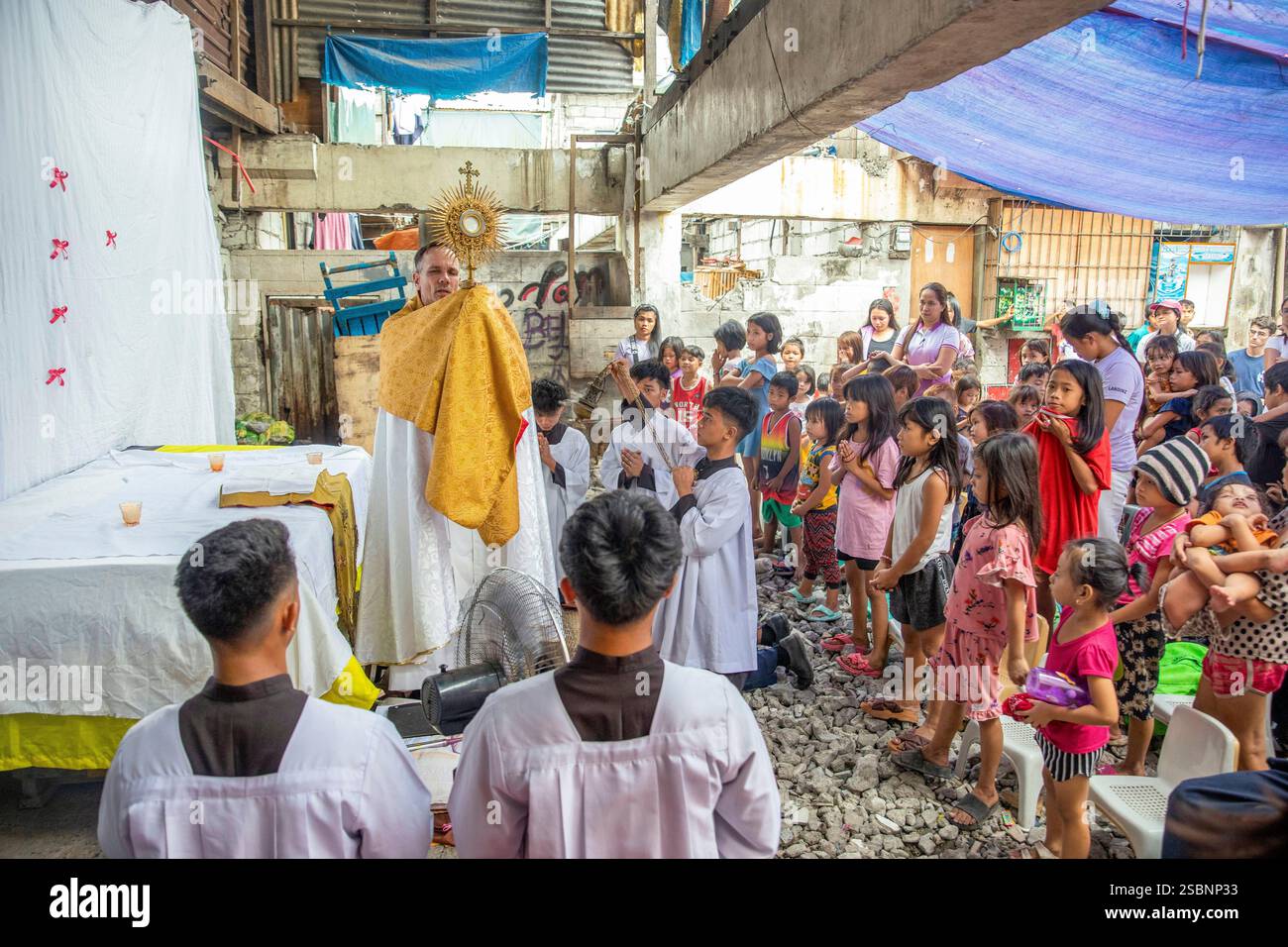 Filippine, Manila, Jundo, Matthieu Dauchez, sacerdote francese a capo della fondazione Anak-TNK, che aiuta i bambini di strada, celebrando la messa per i bambini di strada dopo una processione in una baraccopoli, croce processionale in mano Foto Stock Filippine, Manila, Jundo, Matthieu Dauchez, sacerdote francese a capo della fondazione Anak-TNK, che aiuta i bambini di strada, celebrando la messa per i bambini di strada dopo una processione in una baraccopoli, croce processionale in mano Foto Stock