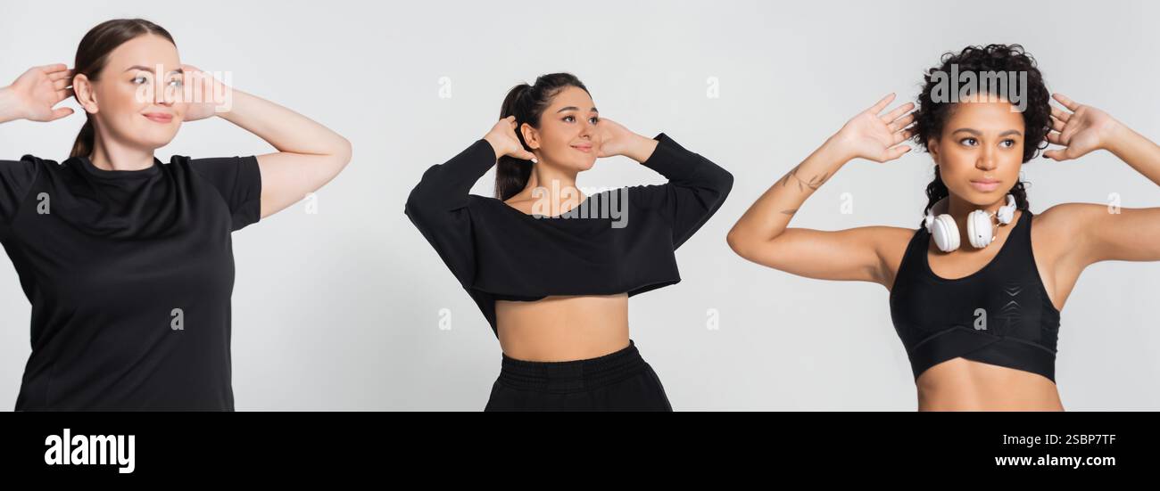 Tre donne sicure di sé dimostrano atletismo mentre si impegnano in una routine di fitness al chiuso. Foto Stock
