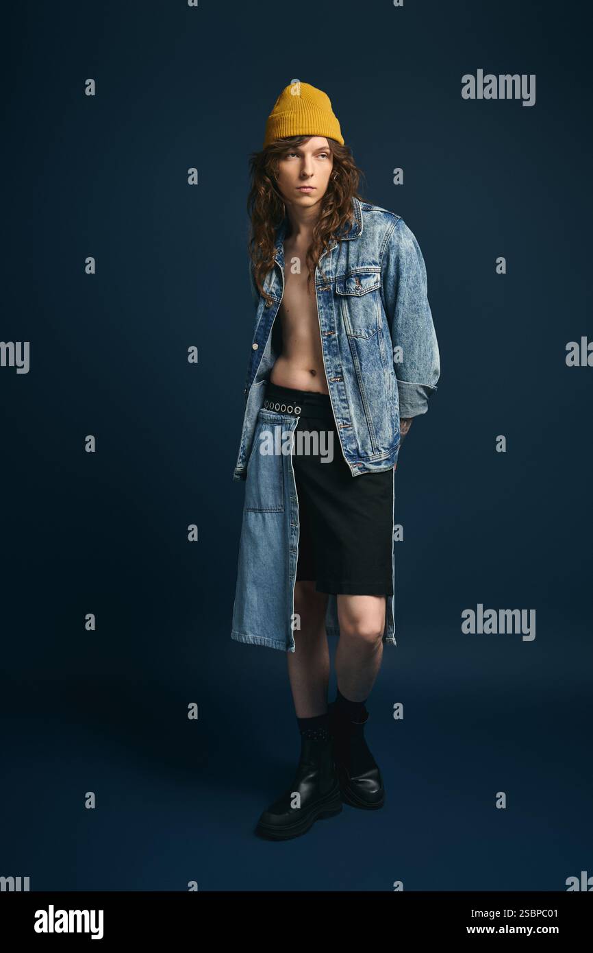 Un bel giovane uomo indossa con sicurezza un outfit casual ma chic, che irradia stile e carisma. Foto Stock