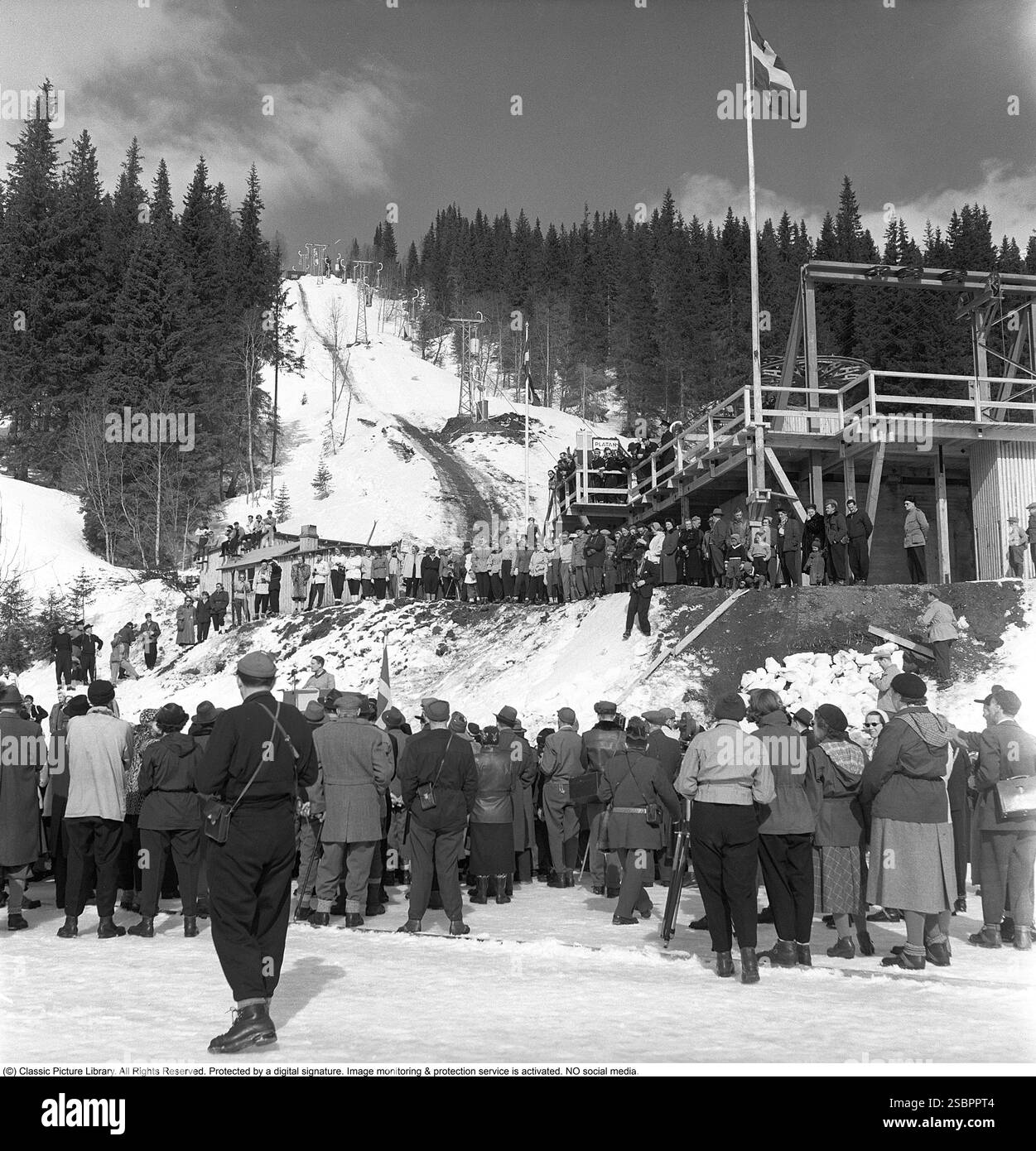 Åre 1952. Popolare località di sport invernali a Jämtland in Svezia, dove la gente va a sciare e socializzare. Åre è conosciuta per la sua lunga storia di sci e gli anni '1950 erano un periodo in cui lo sci era un'attrazione sportiva e turistica in crescita. La foto viene scattata durante il giorno della cerimonia di apertura dello skilift di Åre il 5 aprile 1952. Il Direttore generale delle Ferrovie statali svedesi SJ ha parlato all'inaugurazione. Fu il primo impianto di risalita di Åre. Foto Stock